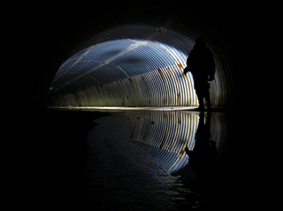 Illustration for article titled Unreal photographs of tunnels look like portals into the underworld